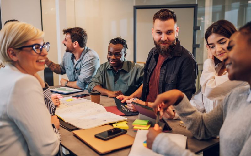 Multicultural professional project managers group negotiating in boardroom at meeting. Creative diverse team discussing the concept of business strategy in their project. Fun at work.